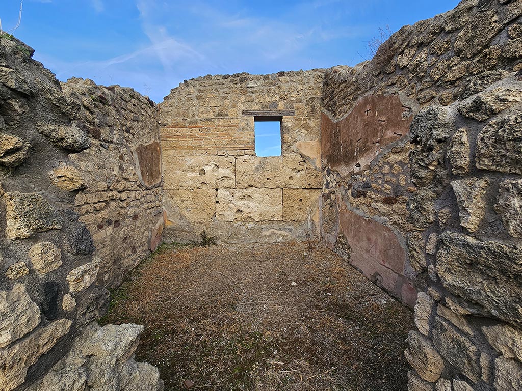 IX.7.21/22 Pompeii. November 2024. 
Looking north through doorway in north-east corner of atrium towards west, north and east walls. Photo courtesy of Annette Haug.
