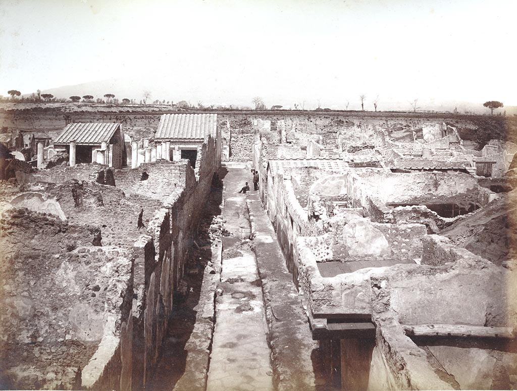 IX.8.6 Pompeii. Photo by Sommer, c.1890, numbered 1298 with work ongoing in the vicolo. The peristyle of IX.8.6 is seen on the left. 
Looking north along unnamed vicolo between IX.8, on left and IX.9, on right. Photo courtesy of Espen B. Andersson.

