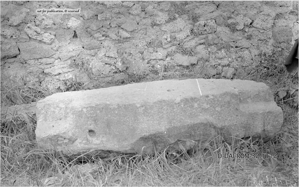 IX.9.6/10 Pompeii. Chest base. 
According to Pernice –
Found in front of the un-plastered long wall of the large courtyard. 
The base was probably in place before the building was remodelled, but due to its weight it was simply left lying there and used for something else. 
No traces of rust can be found on the surface. The notches indicate square feet. The iron spike and the hole that are typical for money box foundations are missing.
See Pernice, E., 1932. Hellenistische Tische, Zisternenmündungen, Beckenuntersätze, Altäre u. Truhen. Berlin, p. 73, Taf. 43.5.
DAIR 32.1112. Photo © Deutsches Archäologisches Institut, Abteilung Rom, Arkiv. 
Thanks to Espen B. Andersson for assisting us in our interest in money-chests.
