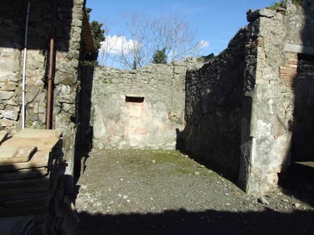 IX.9.d Pompeii. March 2009. Doorway to room f, tablinum, looking towards south-east corner. According to NdS, the flooring was of Opus signinum. The walls were decorated with a red background except in the corners where there was a black background. The lower dado (or zoccolo) was also painted black, whilst the frieze was all red. Of the three square paintings that decorated the centre of the walls, only two remained. On the south wall Narcissus was painted. On the east wall Venus Pescatrice was painted. Both paintings were described as mediocre. In the side panels of the walls, flying cupids could have been seen.
See Notizie degli Scavi, 1889, p.131
On the south wall was found a central wall painting of Narcissus. 
See Schefold, K., 1962. Vergessenes Pompeji. Bern: Francke. (p.173f, and Taf.178,3.)  


