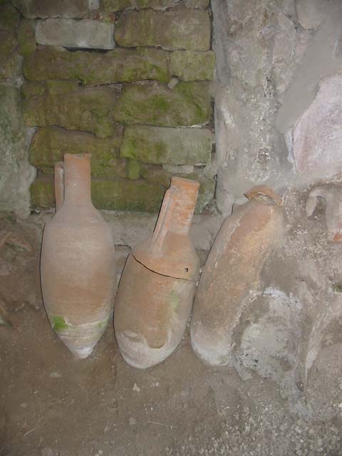 IX.11.2 Pompeii. September 2003. Amphorae in front of blocked door at centre of east wall. Photo courtesy of Nicolas Monteix.