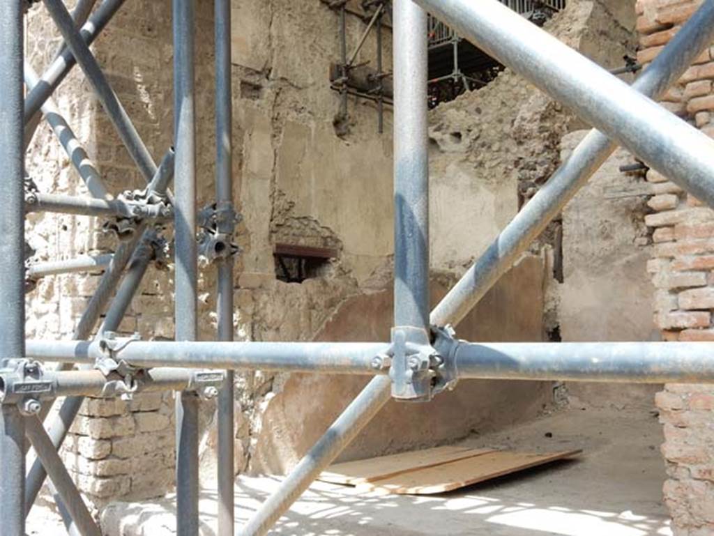 IX.12.7 Pompeii, May 2018. 
Looking towards west wall of shop-room 1, at the left rear of the wall is room “c2” of IX.12.6 with doorway. Photo courtesy of Buzz Ferebee.

