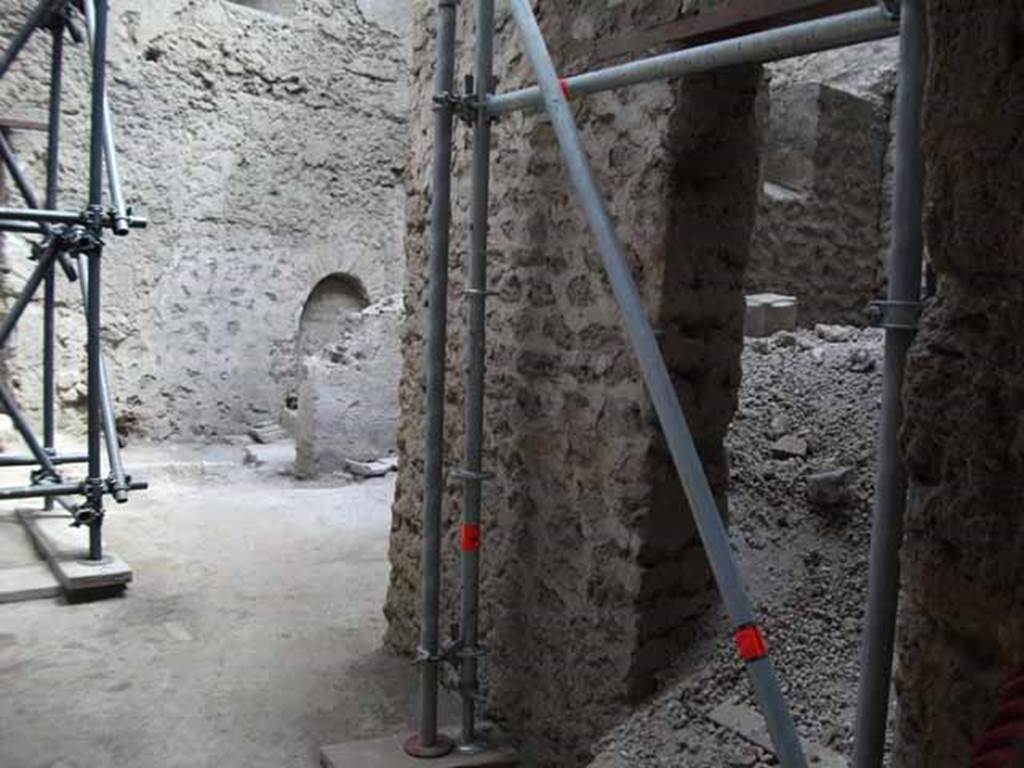 IX.12.9 Pompeii. May 2010. Looking east from portico into room 15 kitchen, and small room 17, unexcavated on right.