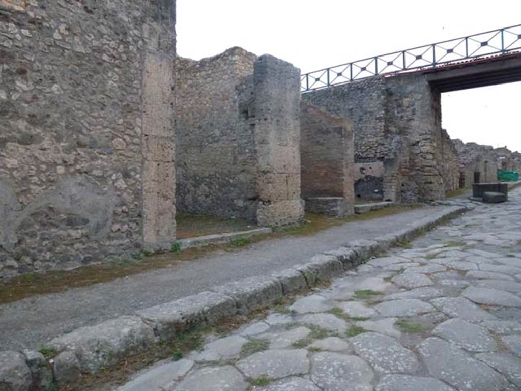 IX.14.3 Pompeii. September 2011. Looking south-west towards entrance doorway, on left, and IX.14.2 and IX.14.1, and modern bridge on Via di Nola. Photo courtesy of Michael Binns.
