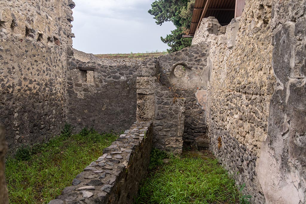 IX.14.4 Pompeii. July 2024. Looking east towards room 8, latrine, on right, and room 7, on left, Photo courtesy of Johannes Eber.