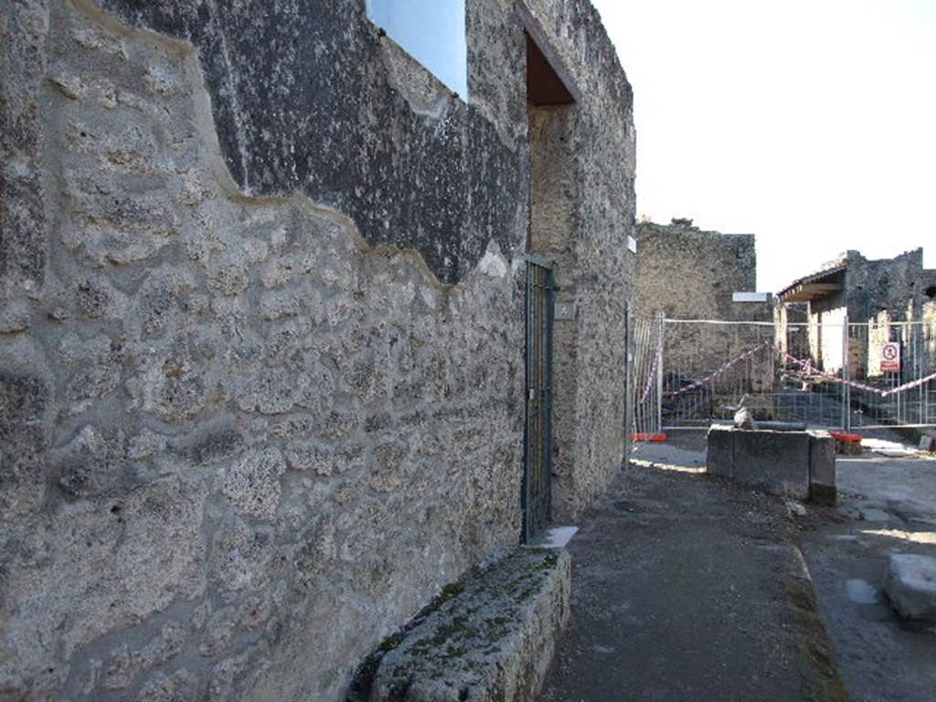 Via di Castricio at I.16.4. December 2006. South side. Looking west to junction with unnamed vicoli. 
