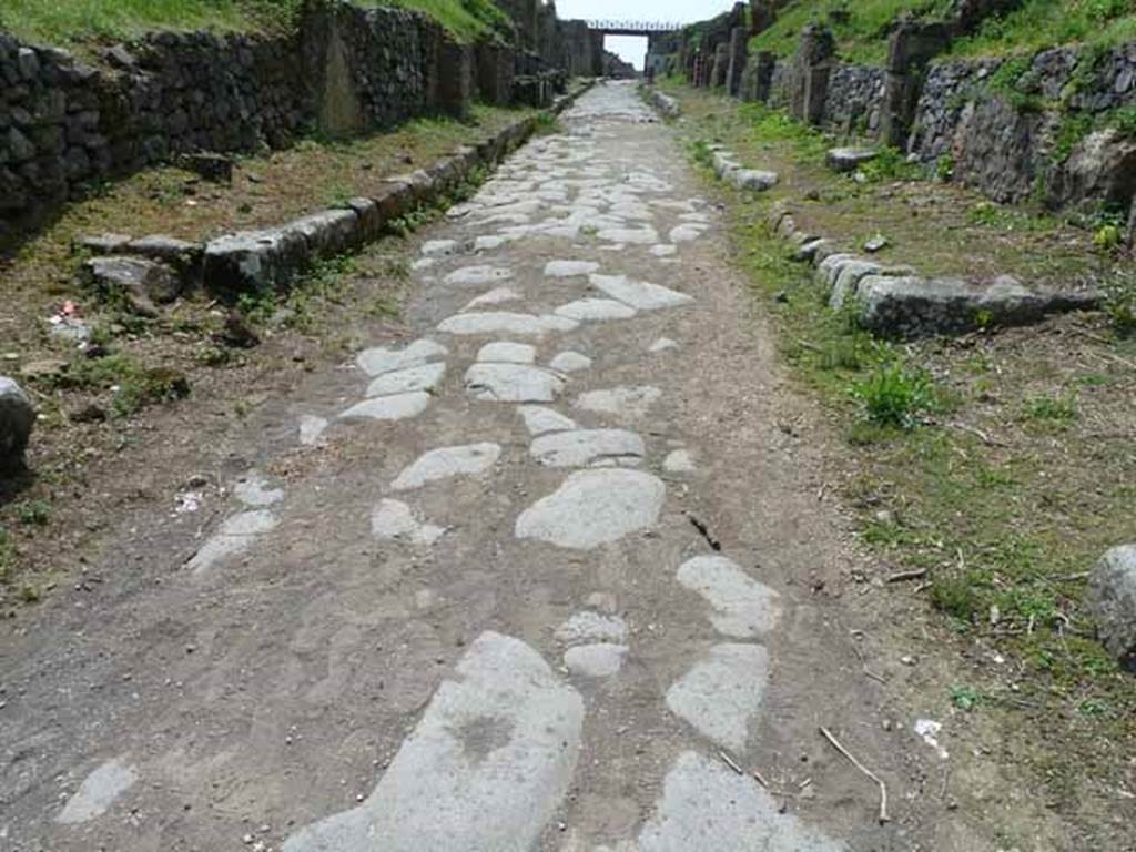 Via di Nola, May 2010.  Looking west between III.9 and IV.3, from junction with unexcavated, unnamed vicoli to both north and south.