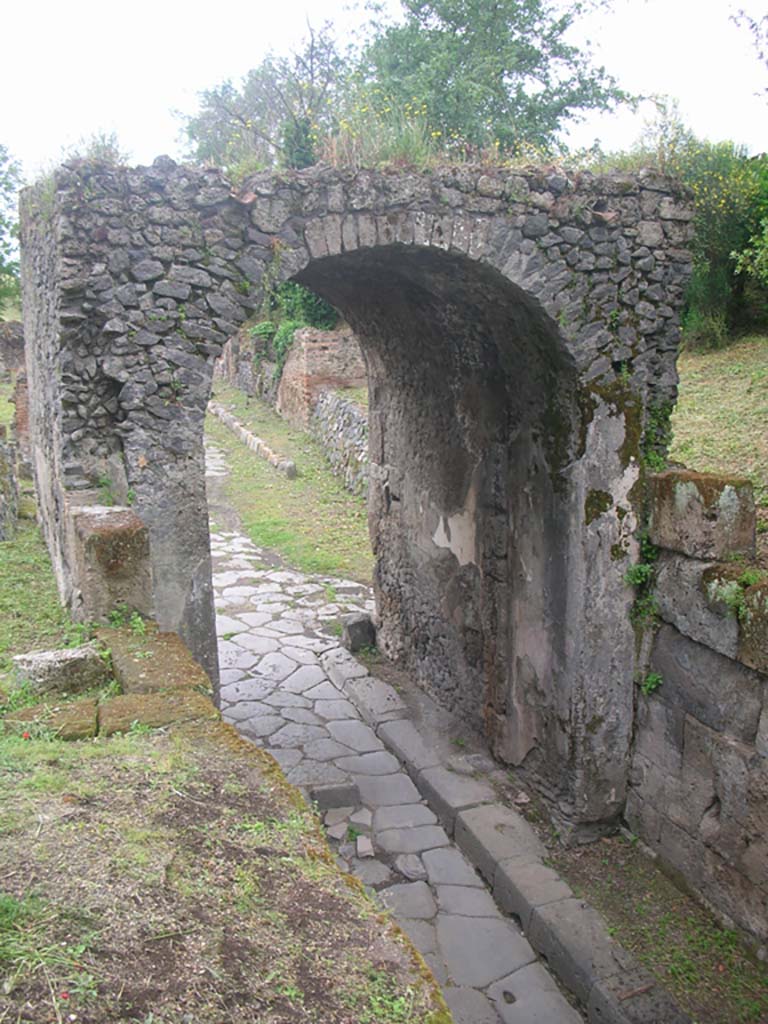 Via di Nola, Pompeii. May 2010. 
Looking west through Nola Gate towards roadway. Photo courtesy of Ivo van der Graaff.
