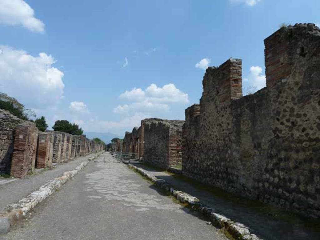 Via di Nola, south side, May 2010. Looking east along IX.4, from junction with Vicolo di Cecilio Giocondo.