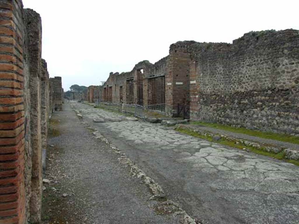 Via di Nola, south side, May 2010. Looking east at IX.4 and the junction with Vicolo di Tesmo, from near V.1.1.