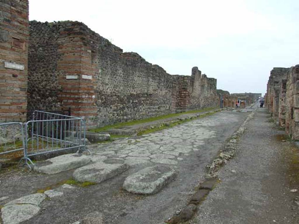 Via di Nola, south side, May 2010. Looking west to the junction with Vicolo di Tesmo, and IX.4.