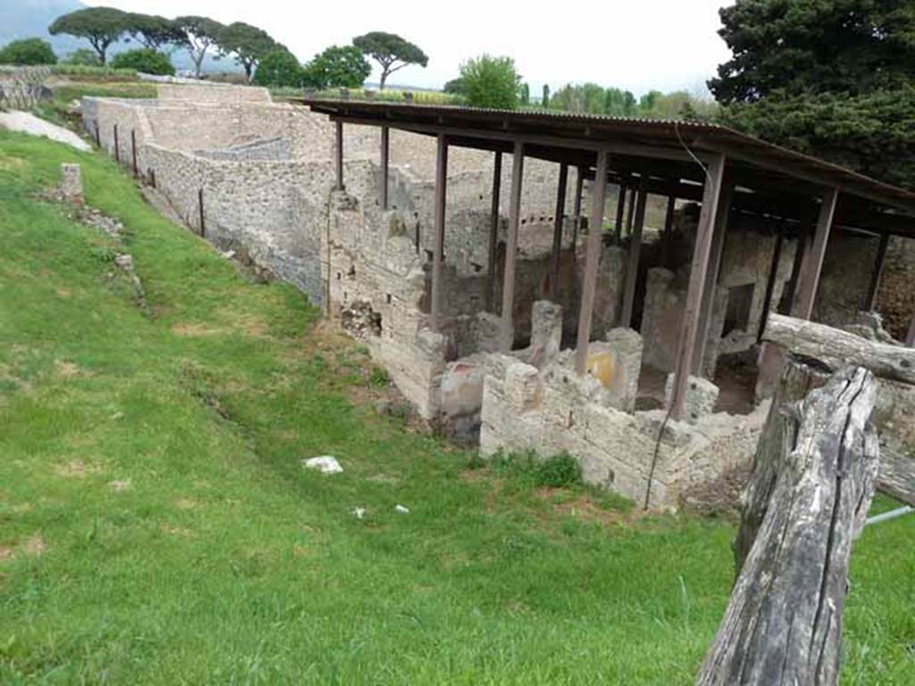 Unnamed vicolo on the west side of IX.14.c, with the modern road bridge on top of it at the Via Nola end,  Pompeii. May 2010. Site of small unexcavated vicolo, showing the west side of IX.14, and the east rear unexcavated side of IX.10. Looking north.
