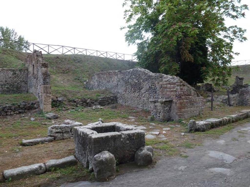 Via di Nola, south side, September 2011. Looking south-west towards III.11.1 on left, fountain, unexcavated vicolo with street altar, and III.10.6 on right. Photo courtesy of Michael Binns.
