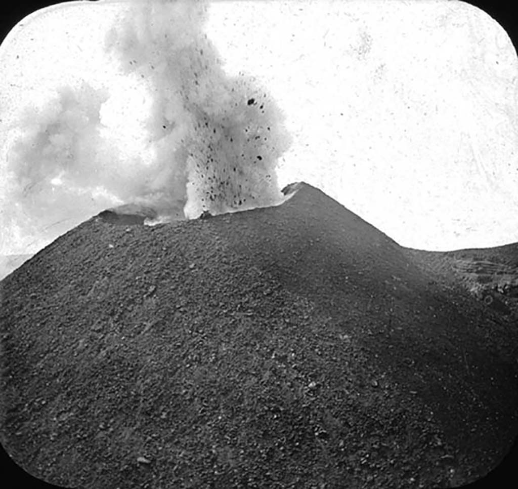 Vesuvius from the air “in one of its slumbering moments”. Press photo dated 10th April 1923 on rear.
Photo courtesy of Rick Bauer.
On the back it says: “An airplane view of Vesuvius. 
This striking view, taken from an airplane, shows Mt. Vesuvius in one of its slumbering moments with just a wisp of steam coming from the crater”.
