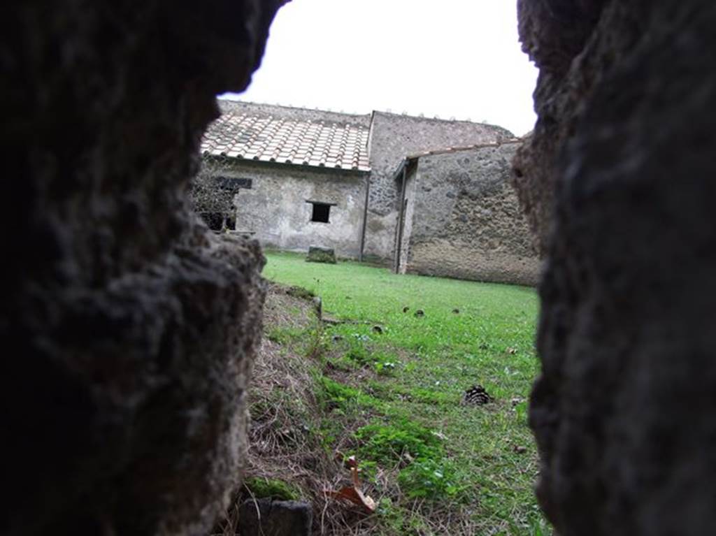 II.9.4 Pompeii. December 2006. Through hole in wall looking west towards kitchen in outbuilding, centre right. 