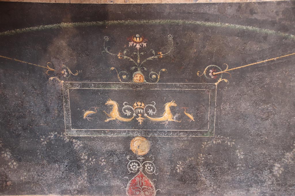 VI.15.1 Pompeii. October 2024. North wall, detail from zoccolo under central painting. Photo courtesy of Klaus Heese.