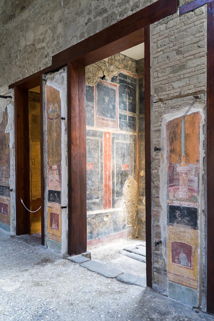 VI.15.1 Pompeii. March 2023. 
Looking east towards north side of entrance vestibule (a) and doorway and vestibule (b), from atrium (c).
Photo courtesy of Johannes Eber.
