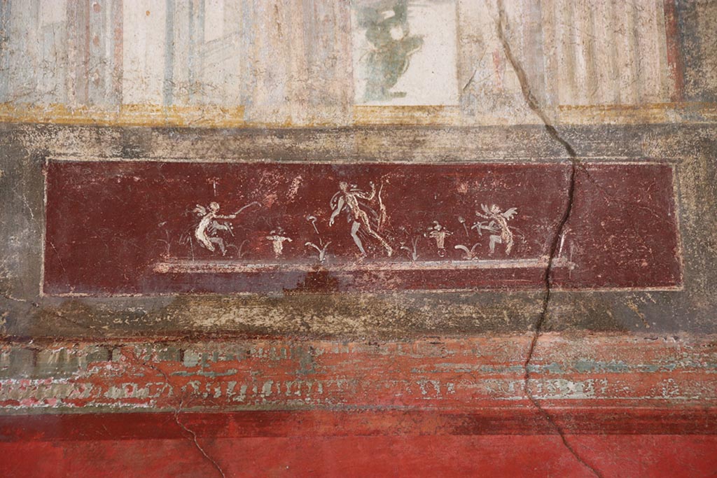 VI.15.1 Pompeii. October 2024. 
Upper north wall of exedra, detail of painted figures on panel towards east end. Photo courtesy of Klaus Heese. 
