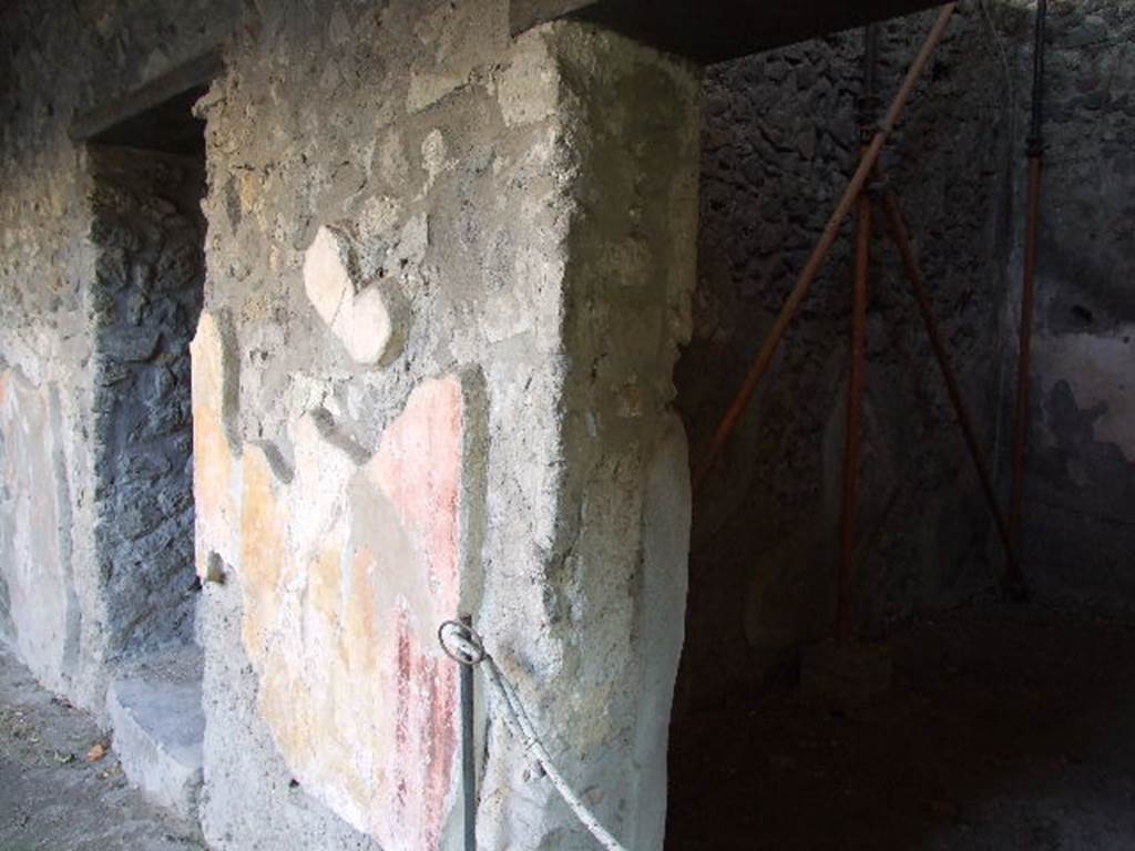 HGW24 Pompeii. December 2006. South wall of baths courtyard, with doorway on left to apodyterium or changing room. On the right is a doorway to a storeroom.
