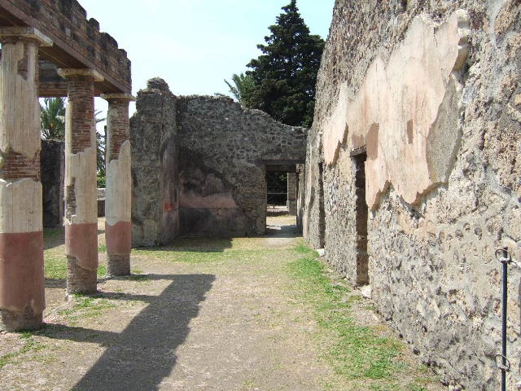 HGW24 Pompeii. May 2006. Looking west along north side of peristyle towards ala.
(Fontaine, north side of courtyard portico was numbered as 2a, the doorway (on right) is actually a niche near to which La Vega No.45, and No.8 were found.

From PAH, addendum, p.127 – (see No.45 below, on the plan by La Vega this was found along this side of the front peristyle).
Relazione delle antichita, che si vanno ritrovando nella masseria del sig. D. Giovanni Milano parsonaro, che si era principiata al di 14 Febbraro 1771. (Report of Antiquities found .....)
 “No.45. Nella stessa date. Si sono trovate due scive di bronzo, ed una grappa delle stesse.” 
“No.45. Of the same date. Two bronze parts of chest, possibly a lock or lock-bolt, and a hook (or reinforcing piece) of the same were found."

PAH addendum, p.158 - 6 Giugno 1772.
Altra bocca di cisterna simile. Vasca in mezzo al cortile, rivestita di marmo; no.43, 44, 45 pianta di La Vega.

