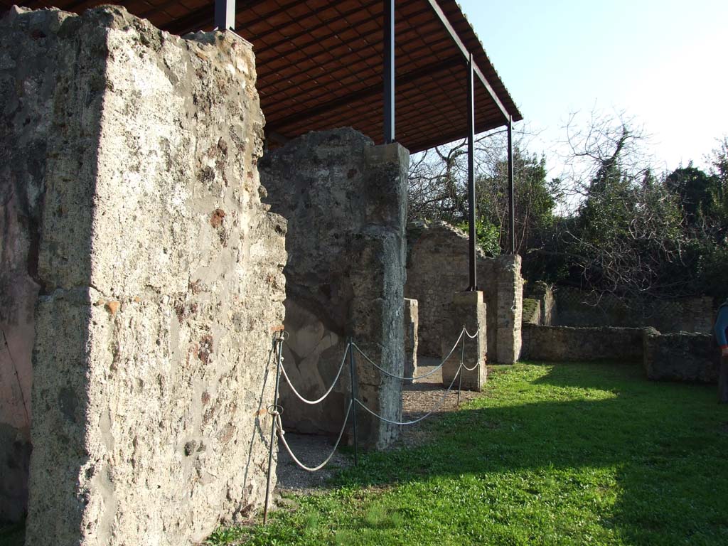 HGW24 Pompeii. December 2006. Looking south along terrace from near the room with window. 
The doorway to the tablinum is hardly visible, on the left. 
“No.3 on the La Vega plan was found in the tablinum on 20th February 1771. This room was decorated with various paintings on a red background, and seen were landscapes, houses in the countryside, baskets with figs, and others: the zoccolo/plinth was black with pretty decorations. The floor was of crushed brick (mattoni pesti), with some white stones used as a mosaic. In the frieze of this room (“at the height of the frieze??”) the vase numbered 1 on the plan by La Vega was found.”
