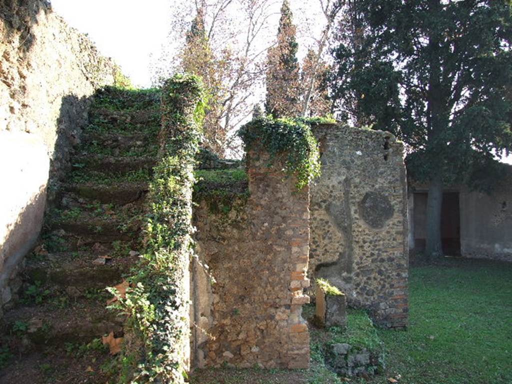 HGE12 Pompeii. December 2006. Looking south towards staircase running up above lararium niche, against east wall.