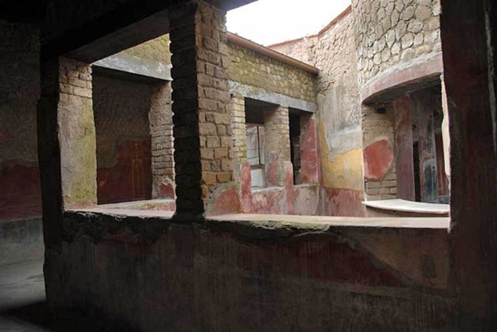 Castellammare di Stabia, Villa San Marco, January 2011. Corridor 32, north wall of windowed portico. Looking into small triangular garden 28, and across it towards apse into room 25.
Photo by Nando Calabrese.


