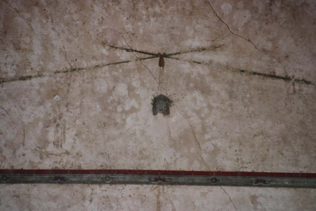 Villa of Mysteries, Pompeii. September 2021. 
Room 11, detail of painted mask from upper centre of south wall. Photo courtesy of Klaus Heese.
