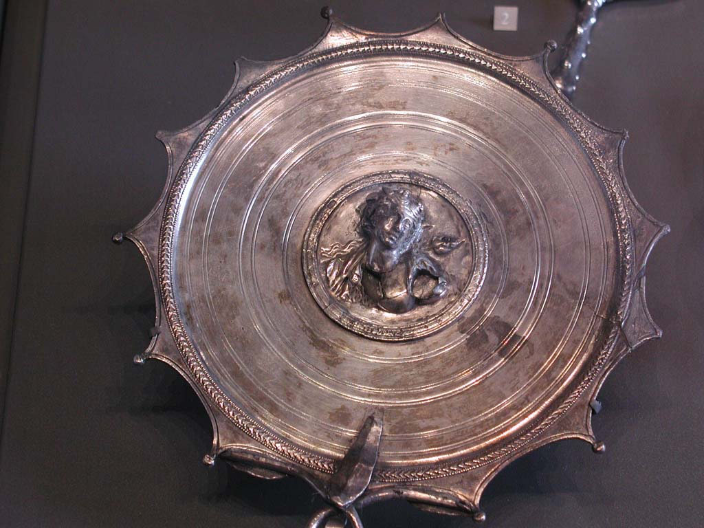 Villa della Pisanella, Boscoreale. Boscoreale silver hand mirror. In the center, in a medallion: bust of Bacchante.
According to De Villefosse, Mirror adorned with the bust of Ariadne and bearing the signature of the engraver M. Domitius Polygnos, with the indication of the weight of the piece.
Miroir  manche. Au centre, dans un mdaillon : buste de Bacchante.
Selon De Villefosse, Miroir orn du buste d'Ariane et portant la signature du ciseleur M. Domitius Polygnos, avec l'indication du poids de la pice.
Now in the Louvre, inventory number BJ2158.
De Villefosse H., 1902. L'argenterie et bijoux d'or du trsor de Boscoreale description des pices conserves au Muse du Louvre - Monuments et Memories 5 1899 with supplement 1902, pl. XIX.
