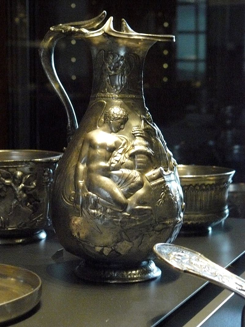 Villa della Pisanella, Boscoreale. Oenocho of the treasure of Boscoreale - Silver wine vase with repousse decorations, traces of gilding, late 1st century AD - Height about 25 cm. Side 1.
On the collar a winged genius gives water to a griffin. On the body one of two Victories sacrificing a bull on either side of an altar bearing the palladium.

Oenocho du trsor de Boscoreale - Vase  vin en argent dcors repouss, traces de dorure, fin du Ier sicle ap. J.C. - Hauteur environ 25 cm. Ct 1.
Sur le col un gnie ail abreuvant un griffon. Sur la panse lun des deux Victoires sacrifiant un taureau de part et d'autre d'un autel portant le palladion.

Now in the Louvre, Inventory number BJ 1899.
